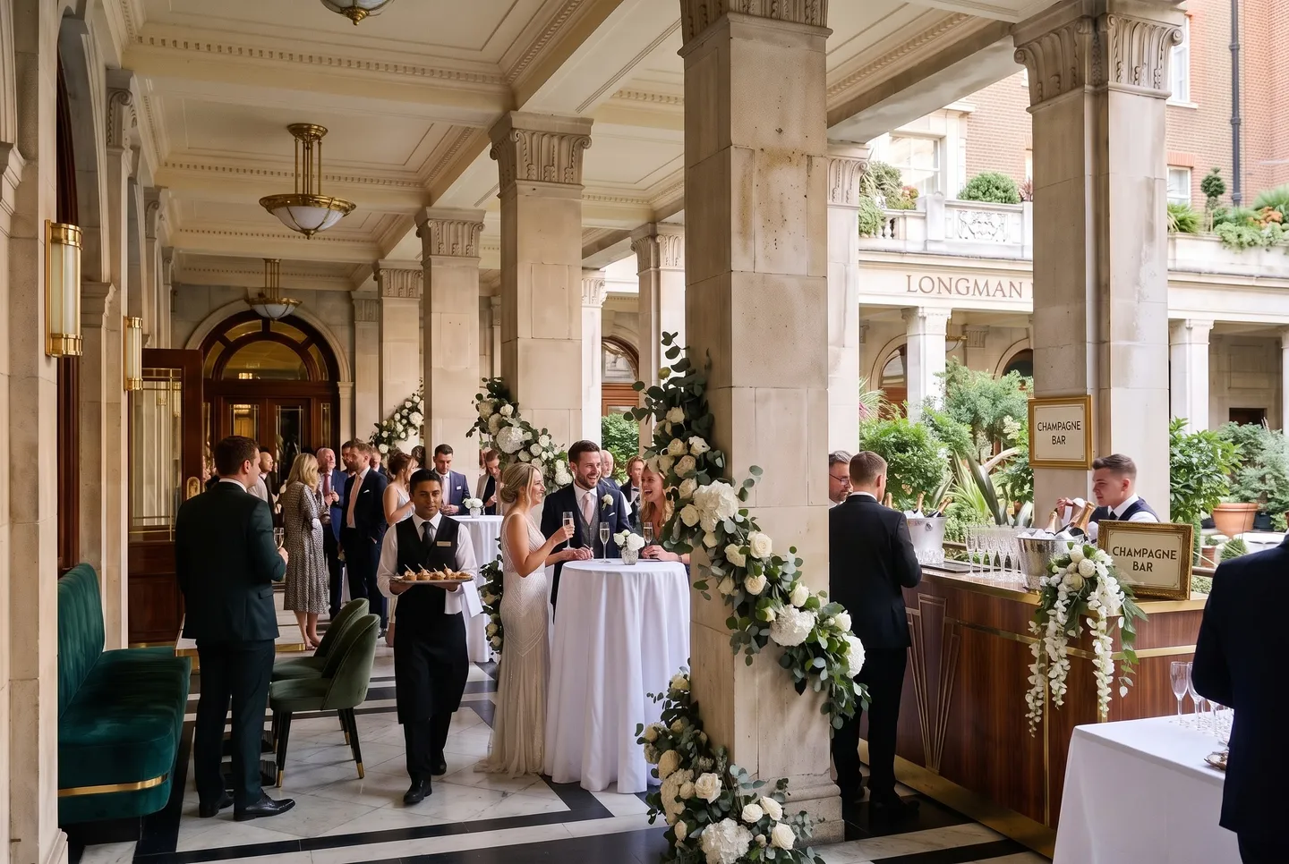 Guests mingle with champagne between the columns at a drinks reception in the Colonnade at Longman Hotel