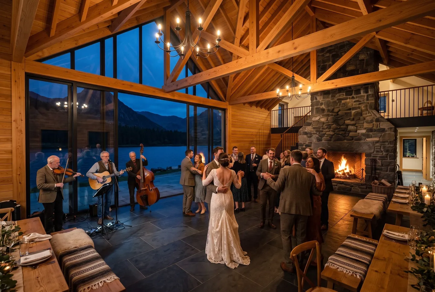 Guests dance in front of the fire as a folk band plays in the Great Hall at Mountain Lodge