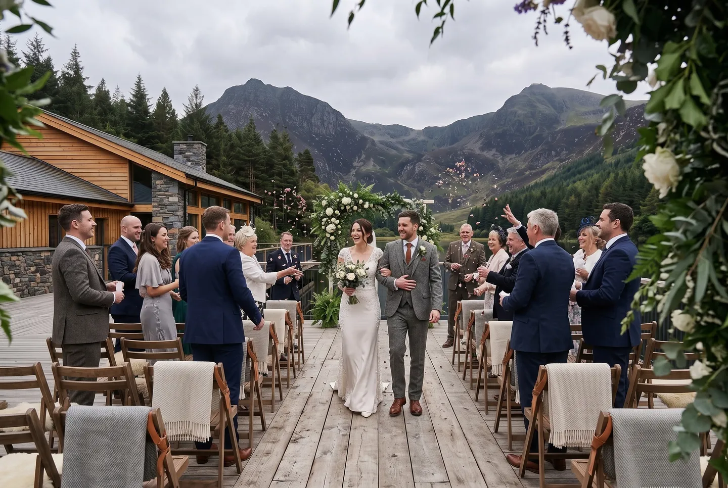 Guests cheer as a just-married couple walk back up the aisle on the Lakeside Deck at Mountain Lodge