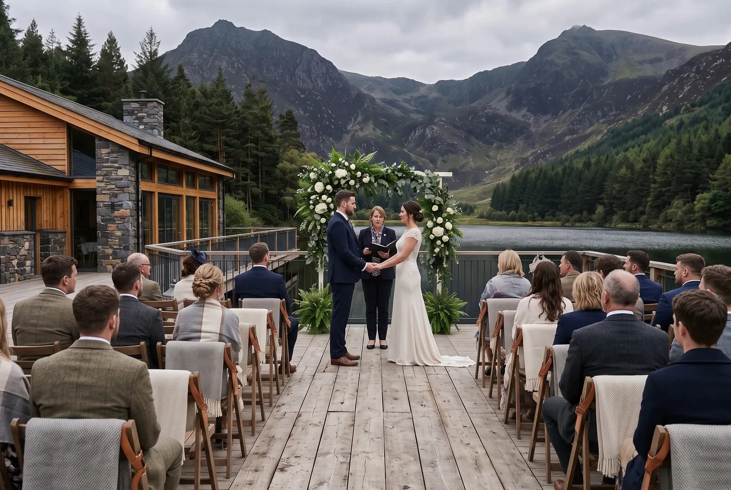 A couple exchange vows under a flower arch on the Lakeside Deck at Mountain Lodge