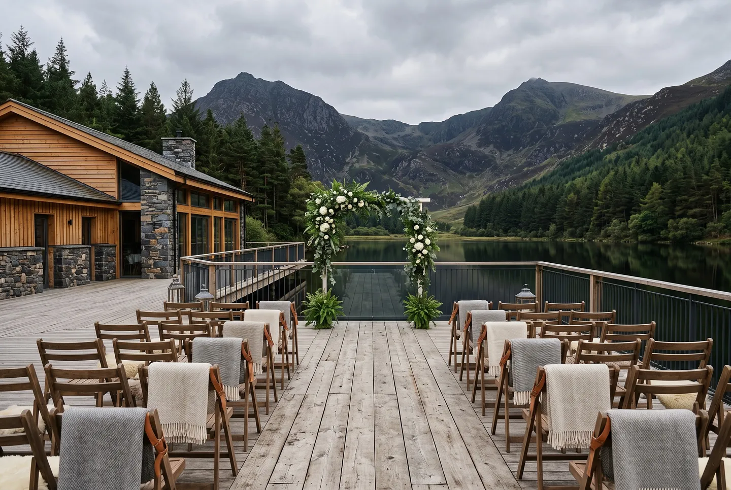 The Lakeside Deck at Mountain Lodge set for a ceremony, with a flower arch facing the lake and mountains